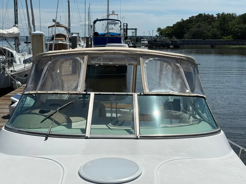 Slide: The Image of 2000 Cruisers Yachts 3375 Express docked at marina, front view. - 11