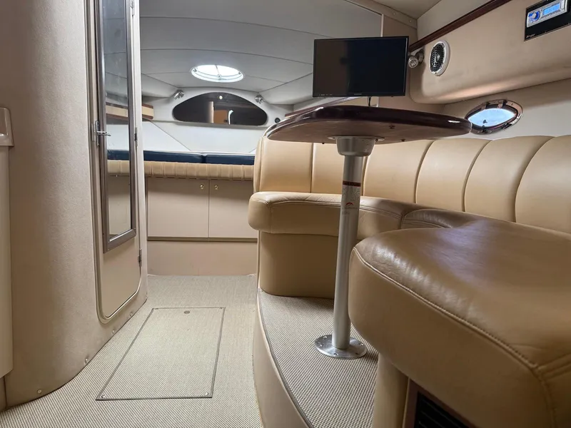 Slide: The Image of Interior of 2000 Cruisers Yachts 3375 Express with beige seating and table. - 18