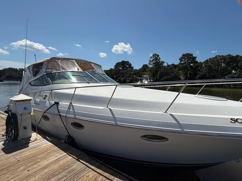 Slide: The Image of 2000 Cruisers Yachts 3375 Express docked, showcasing sleek design and spacious deck. - 3