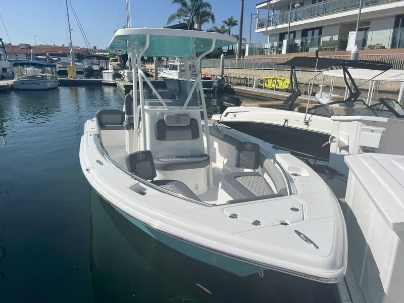 Slide: The Image of 2026 Reflex Gladiator 2400 boat docked in a marina, featuring sleek design and modern amenities. - 10