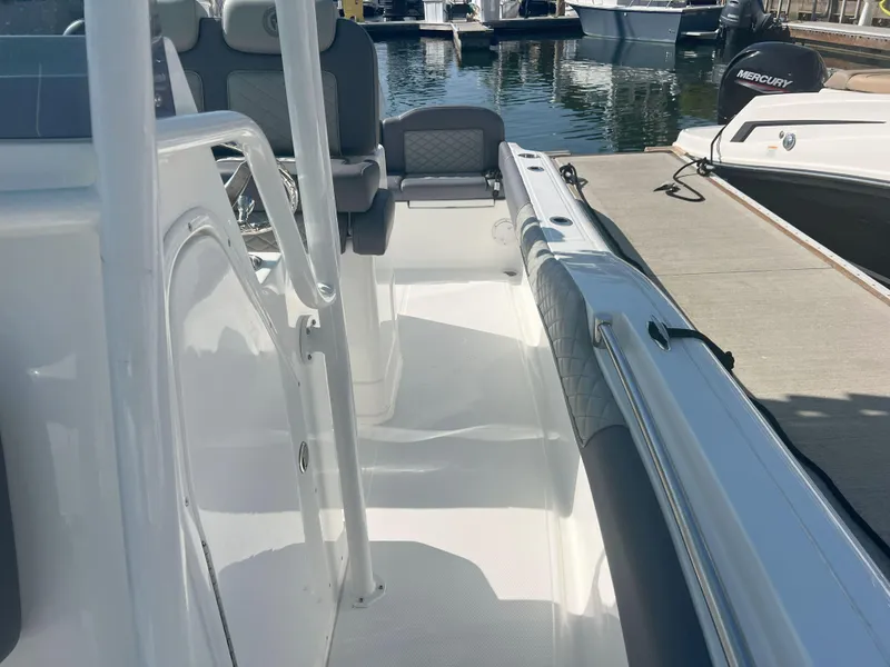 Slide: The Image of Reflex Gladiator 2400 boat interior, 2026 model, docked at marina with seating and controls. - 18
