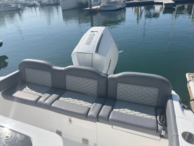 Slide: The Image of Luxury seating on a 2026 Reflex Gladiator 2400 boat at a marina. - 21