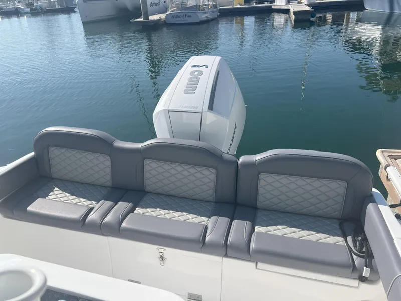 Slide: The Image of Luxury boat seating with diamond-pattern upholstery, Reflex Gladiator 2400, 2026 model, docked at marina. - 30
