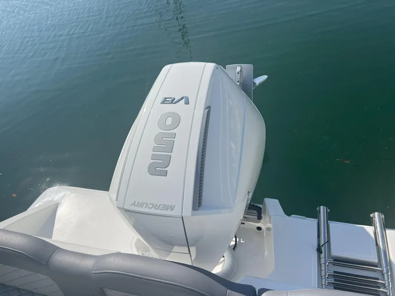 Slide: The Image of Outboard motor on Reflex Gladiator 2400 boat, 2026 model, near water. - 33
