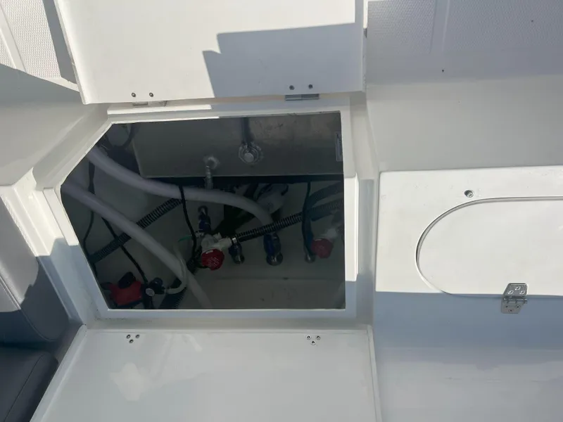 Slide: The Image of Open hatch revealing internal components of Reflex Gladiator 2400 boat, model year 2026. - 35