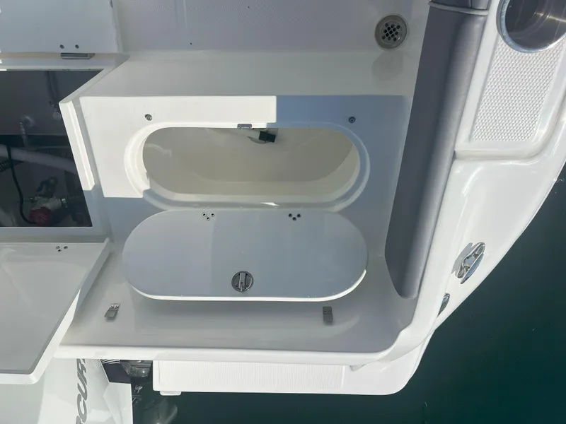 Slide: The Image of Open storage compartment on Reflex Gladiator 2400 boat, 2026 model, with sleek white design. - 36