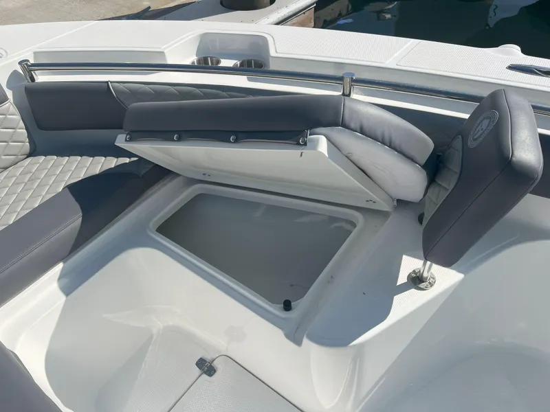 Slide: The Image of Open storage compartment on 2026 Reflex Gladiator 2400 boat with cushioned seating. - 37