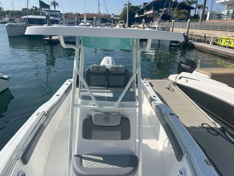 Slide: The Image of Modern Reflex Gladiator 2400 boat docked in marina, showcasing sleek design and spacious seating. - 39
