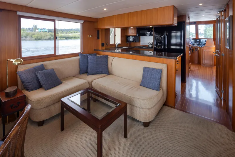 Slide: The Image of Luxurious interior of 2006 Alaskan 65 Flushdeck yacht with cozy seating and modern kitchen. - 11