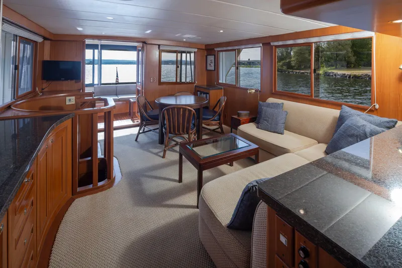 Slide: The Image of Luxurious interior of 2006 Alaskan 65 Flushdeck yacht with elegant wood finishes and waterfront views. - 12