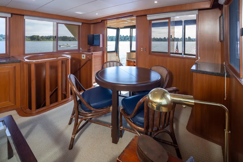 Slide: The Image of Luxurious interior of 2006 Alaskan 65 Flushdeck yacht with elegant wood finishes and lake view. - 13