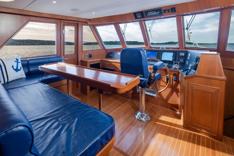 Slide: The Image of Luxurious interior of 2006 Alaskan 65 Flushdeck yacht with blue seating and navigation controls. - 14