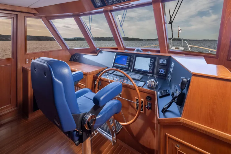 Slide: The Image of Pilothouse of 2006 Alaskan 65 Flushdeck yacht with blue captain's chair and navigation equipment. - 15