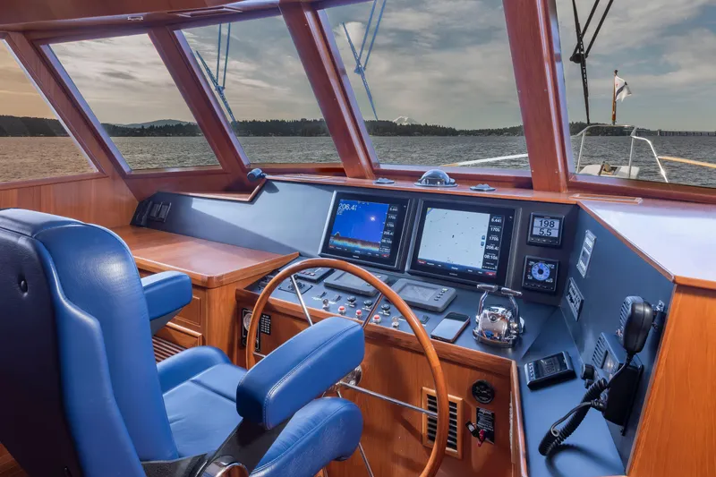 Slide: The Image of Helm of 2006 Alaskan 65 Flushdeck yacht with navigation screens and blue captain's chair. - 16