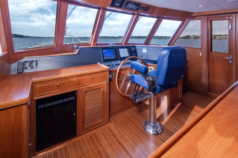 Slide: The Image of Pilothouse of 2006 Alaskan 65 Flushdeck yacht with wooden interior and blue captain's chair. - 17