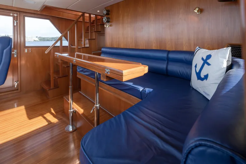 Slide: The Image of Luxurious interior of 2006 Alaskan 65 Flushdeck yacht with blue seating and nautical decor. - 18