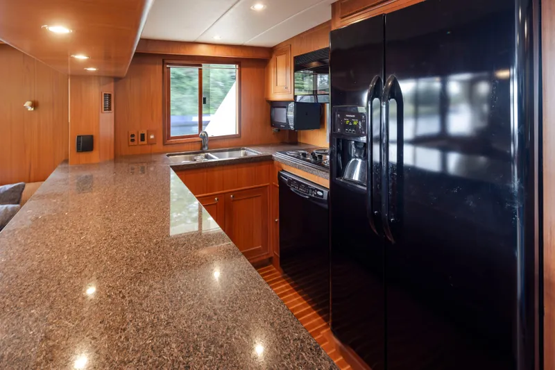 Slide: The Image of Luxurious kitchen interior of 2006 Alaskan 65 Flushdeck yacht with granite countertops and modern appliances. - 20