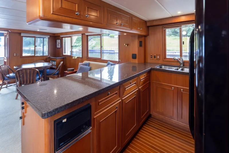 Slide: The Image of Luxurious 2006 Alaskan 65 Flushdeck yacht interior with elegant wood cabinetry and spacious dining area. - 22