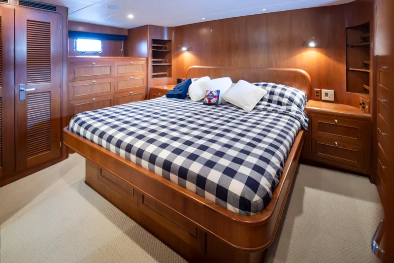 Slide: The Image of Luxurious bedroom in 2006 Alaskan 65 Flushdeck yacht with checkered bedding and wooden cabinetry. - 23