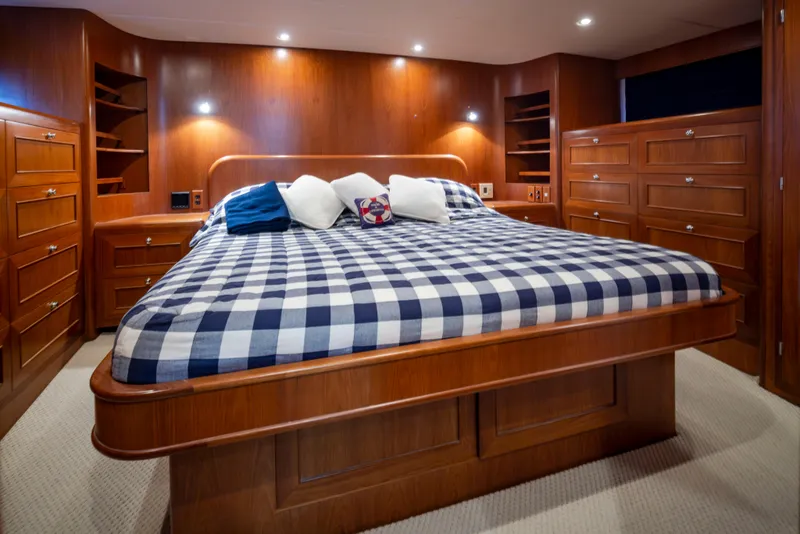 Slide: The Image of Luxurious bedroom in 2006 Alaskan 65 Flushdeck yacht with wood paneling and checkered bedding. - 24