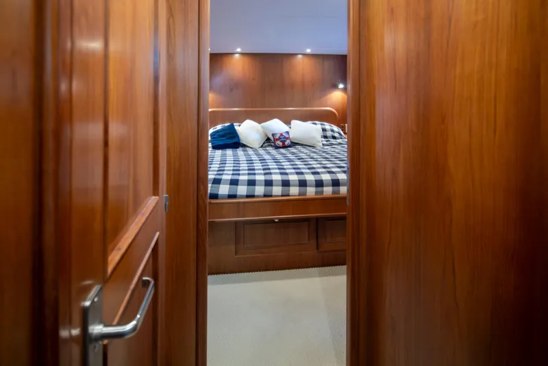 Slide: The Image of Luxurious cabin interior of 2006 Alaskan 65 Flushdeck yacht with cozy bed and wooden finish. - 27