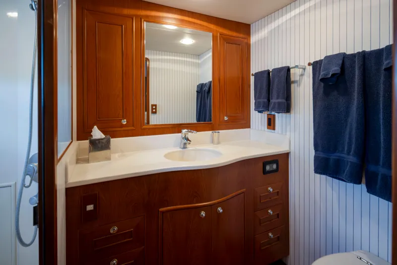 Slide: The Image of Luxurious bathroom in 2006 Alaskan 65 Flushdeck yacht with wood cabinetry and blue towels. - 28
