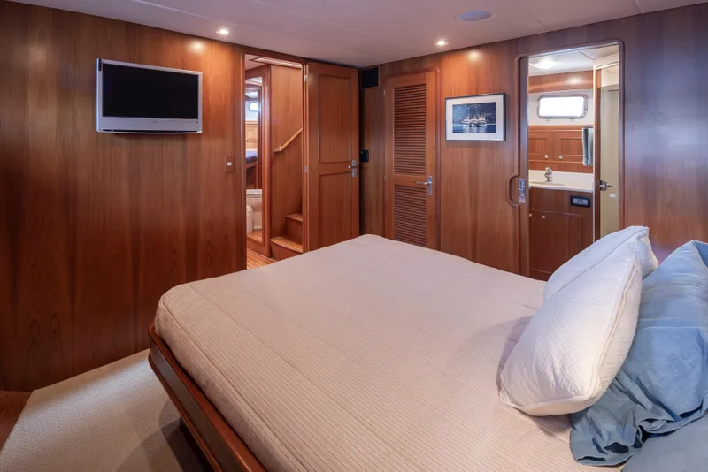 Slide: The Image of Luxurious bedroom interior of 2006 Alaskan 65 Flushdeck yacht with wood paneling and modern amenities. - 35