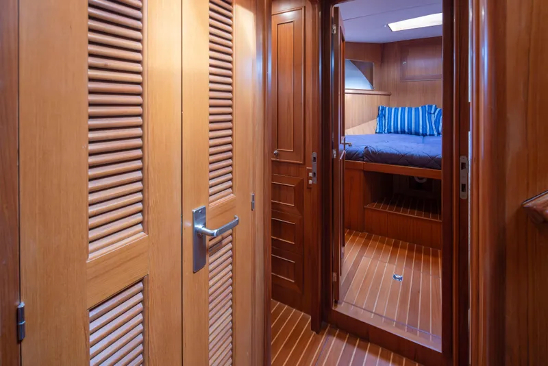 Slide: The Image of Luxurious wooden interior of 2006 Alaskan 65 Flushdeck yacht cabin with bed and striped pillows. - 38