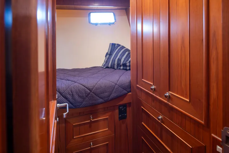 Slide: The Image of Cozy cabin interior of 2006 Alaskan 65 Flushdeck yacht with wooden paneling and bed. - 41