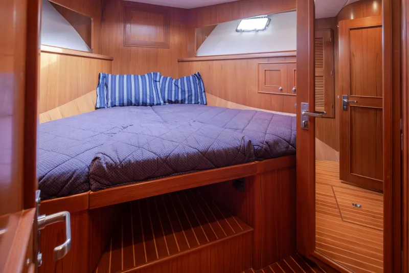 Slide: The Image of Luxurious cabin interior of 2006 Alaskan 65 Flushdeck yacht with wooden finish and cozy bedding. - 43
