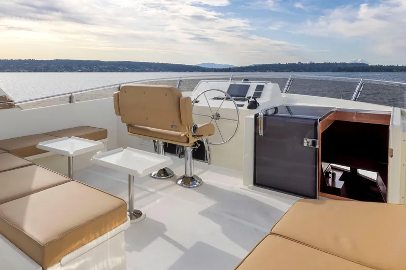 Slide: The Image of Luxurious 2006 Alaskan 65 Flushdeck yacht interior with seating and helm, overlooking serene waters. - 49