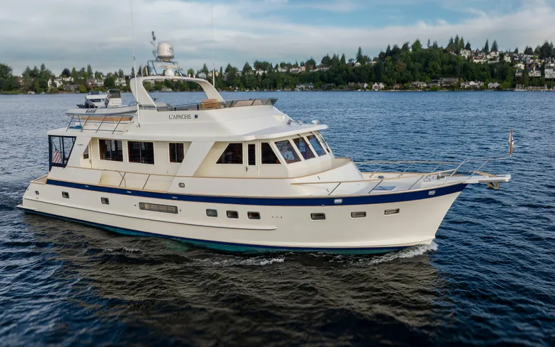 Slide: The Image of 2006 Alaskan 65 Flushdeck yacht cruising on a scenic lake with lush shoreline. - 5