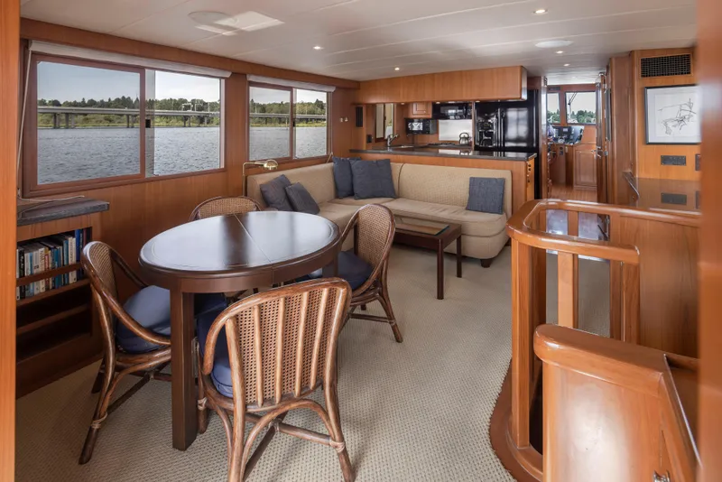 Slide: The Image of Luxurious interior of 2006 Alaskan 65 Flushdeck yacht with dining area and scenic windows. - 9