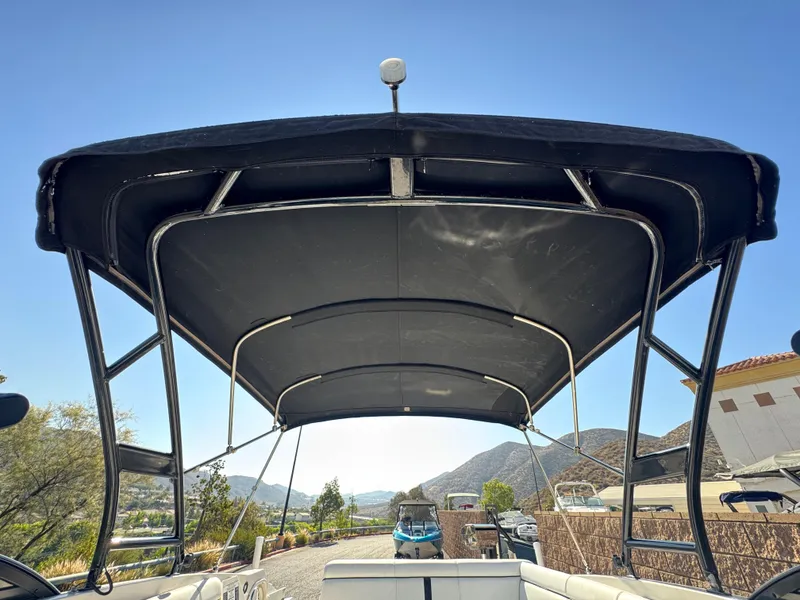 Slide: The Image of 2015 Sea Ray 270 SDX boat with black canopy, scenic mountain background. - 16