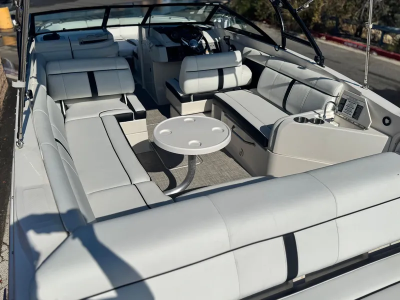Slide: The Image of 2015 Sea Ray 270 SDX boat interior with white seating and round table. - 17
