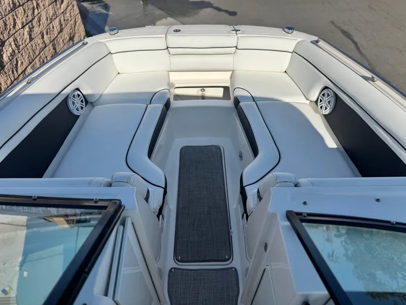 Slide: The Image of 2015 Sea Ray 270 SDX boat interior with white seating and speakers. - 18