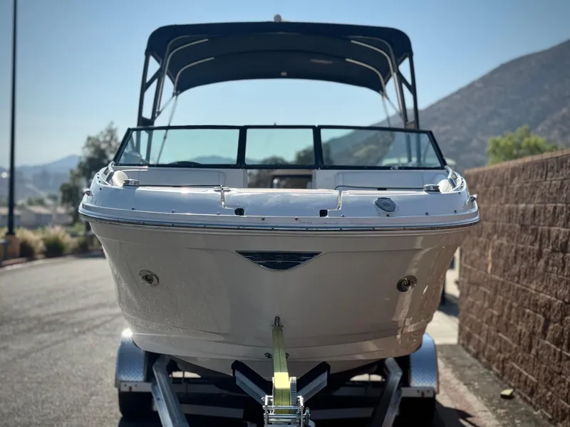 Slide: The Image of 2015 Sea Ray 270 SDX boat on trailer, front view, sunny day, mountainous background. - 2