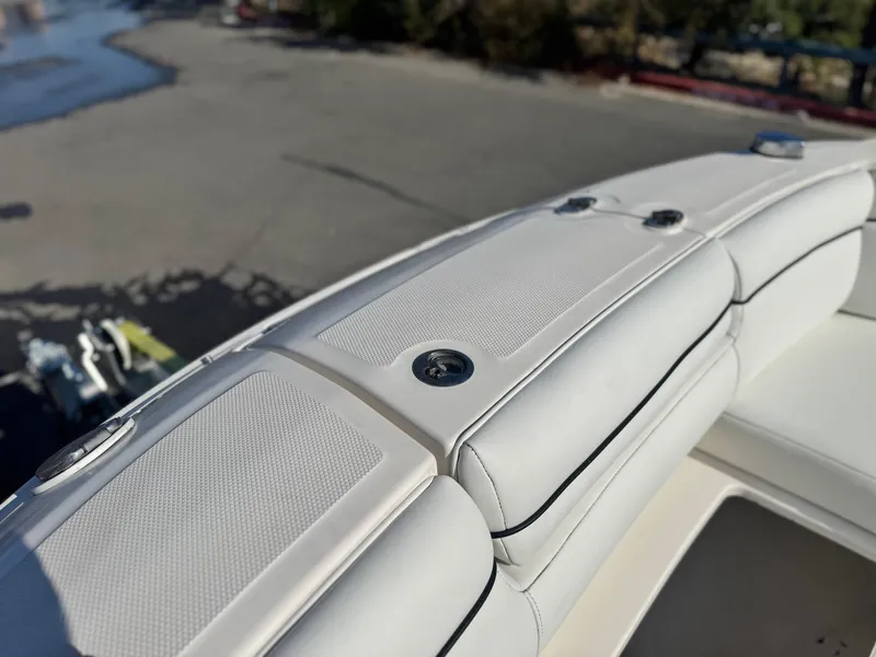 Slide: The Image of 2015 Sea Ray 270 SDX boat interior with white cushioned seating. - 20