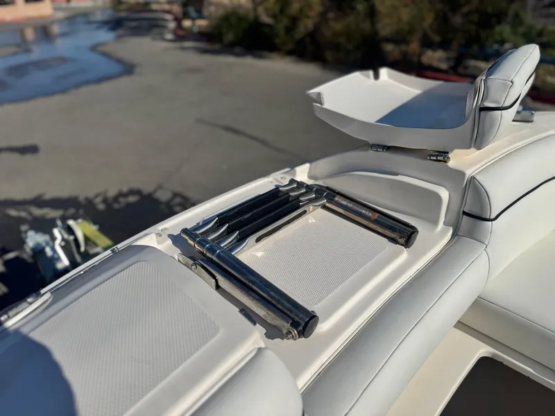 Slide: The Image of 2015 Sea Ray 270 SDX boat interior with seating and storage compartments. - 21