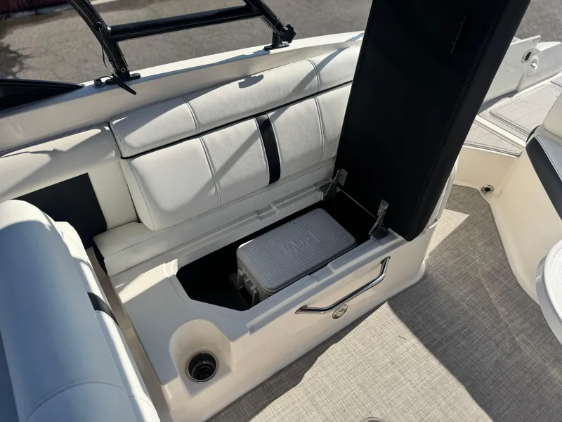 Slide: The Image of 2015 Sea Ray 270 SDX boat interior with open storage compartment and cooler. - 25