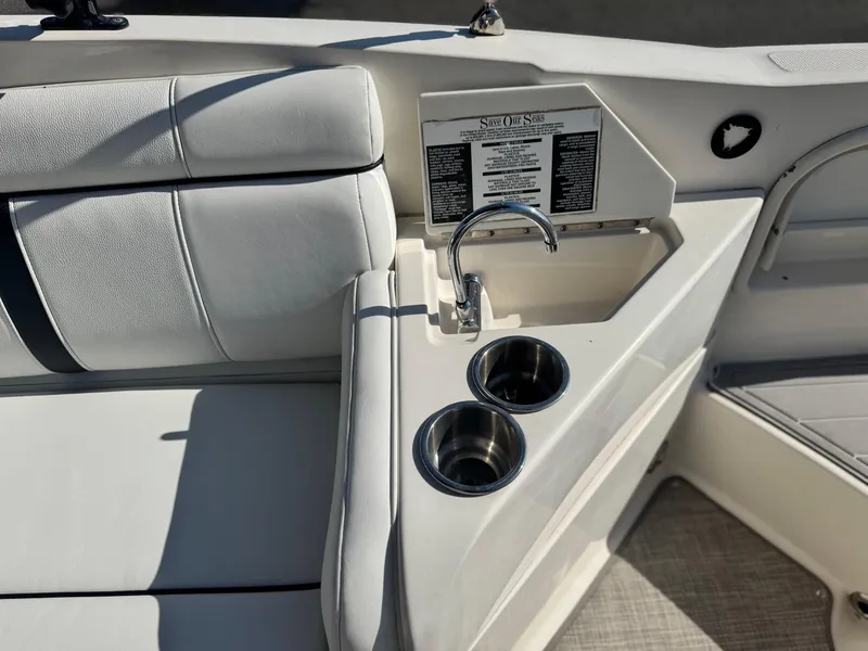 Slide: The Image of Interior of 2015 Sea Ray 270 SDX boat with sink and cup holders. - 27
