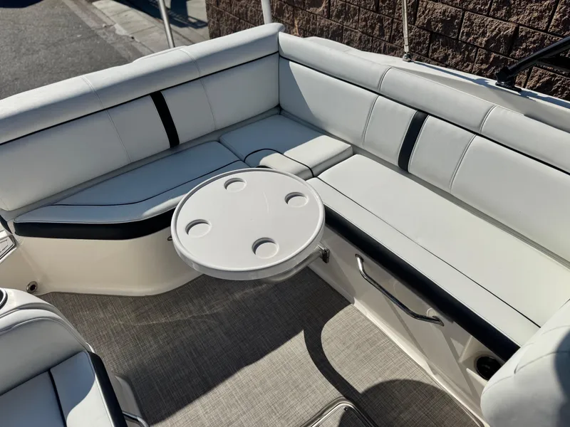 Slide: The Image of 2015 Sea Ray 270 SDX boat interior with white seating and round table. - 28