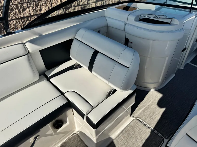 Slide: The Image of Interior seating of a 2015 Sea Ray 270 SDX boat, featuring white and black upholstery. - 31