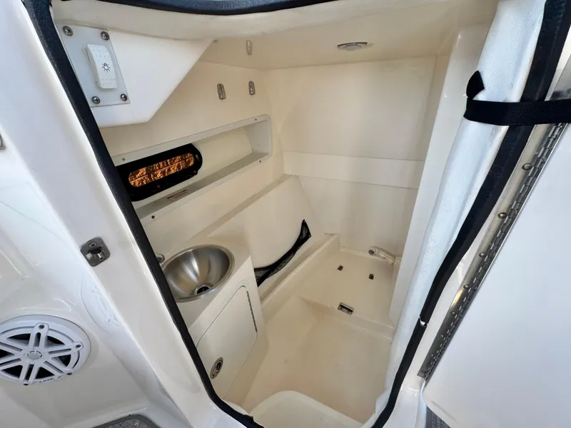 Slide: The Image of Interior of 2015 Sea Ray 270 SDX boat, featuring a compact bathroom with sink. - 33