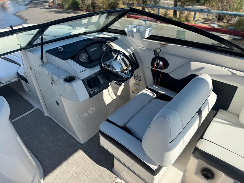 Slide: The Image of 2015 Sea Ray 270 SDX boat cockpit with steering wheel and seating. - 35