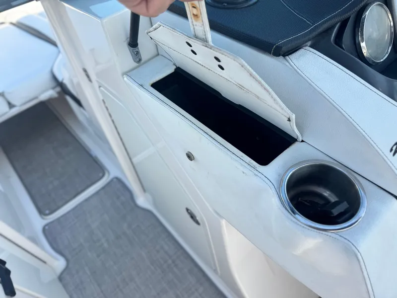Slide: The Image of Interior of 2015 Sea Ray 270 SDX boat showing storage compartment and cup holder. - 38