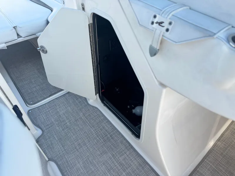 Slide: The Image of Open storage compartment on 2015 Sea Ray 270 SDX boat with gray flooring. - 39