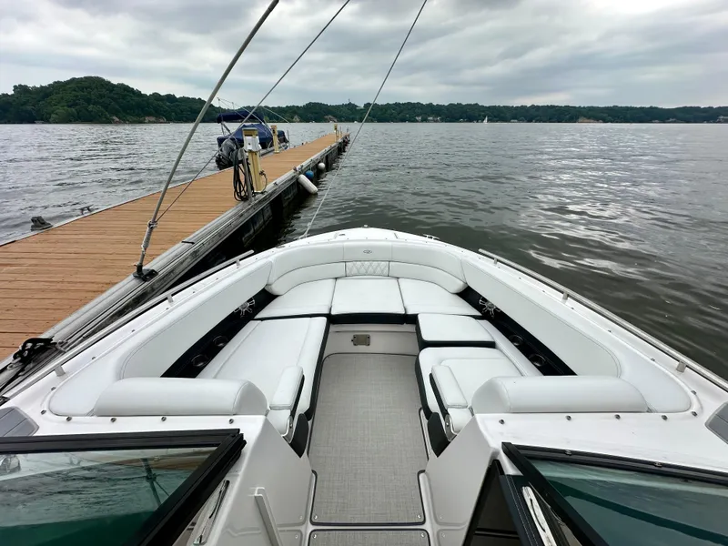 Slide: The Image of 2023 Regal 2800 Bowrider docked on a calm lake with overcast skies. - 14