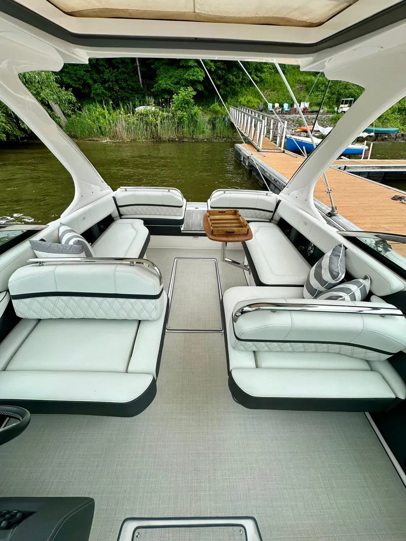 Slide: The Image of 2023 Regal 2800 Bowrider interior with luxurious seating and elegant design by the dock. - 17