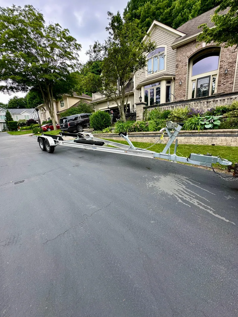 Slide: The Image of Trailer for 2023 Regal 2800 Bowrider parked on residential street. - 22